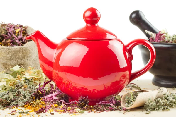 Red teapot, mortar and pestle, sack with healing herbs — Stock Photo, Image