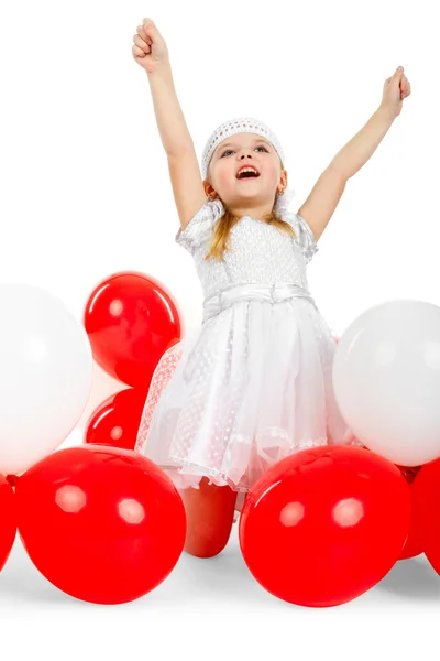 Happy girl with hands up next to balloons — Stock Photo, Image