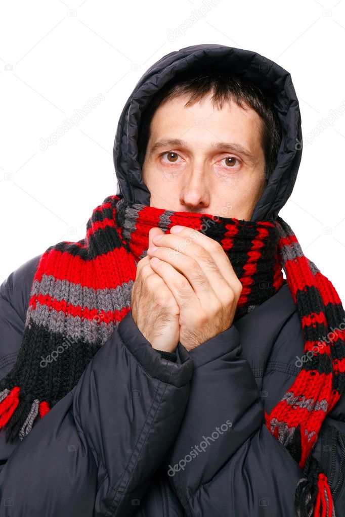 Man in winter clothes shivering from the cold