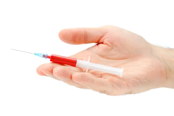 Hand holds the syringe with red contents — Stock Photo, Image