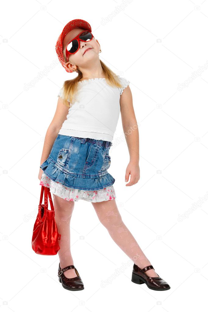 Fashion girl in sunglasses with a red handbag, in catwalk model