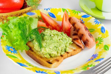 Sandwich with guacamole, grilled sausage and vegetables clipart