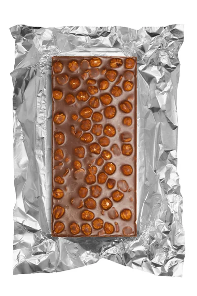 Chocolate bar with hazelnuts in aluminum foil — Stock Photo, Image