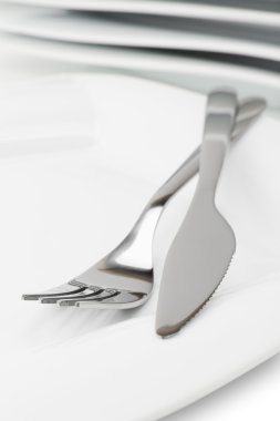 White empty dish, knife and fork clipart