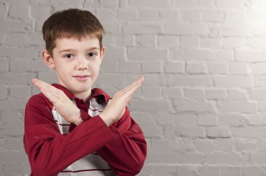 Boy with crossed arms in the form X clipart