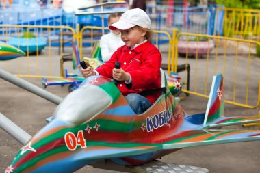 Driving on an attraction in park clipart