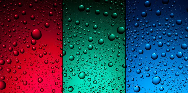 Water drops on red, green and blue backgrounds — Stock Photo, Image