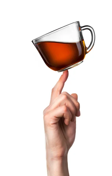 Xícara de chá equilibrada no dedo isolado no branco — Fotografia de Stock