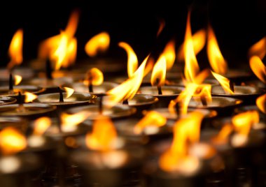 Close up of Candles at Buddhist temple clipart