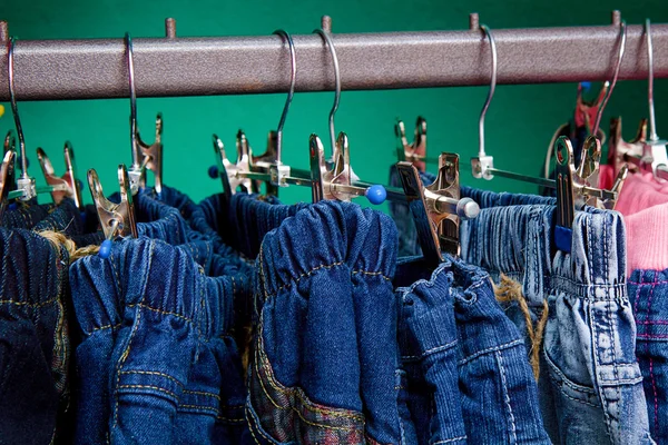 Denim pants on a hanger for children in the store — Stock Photo, Image