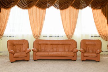 Leather armchairs and a sofa clipart