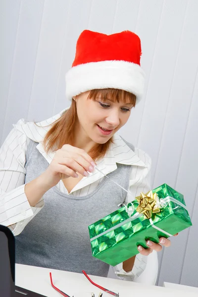 Meisje in het kantoor met een nieuwe jaar cadeau — Stockfoto