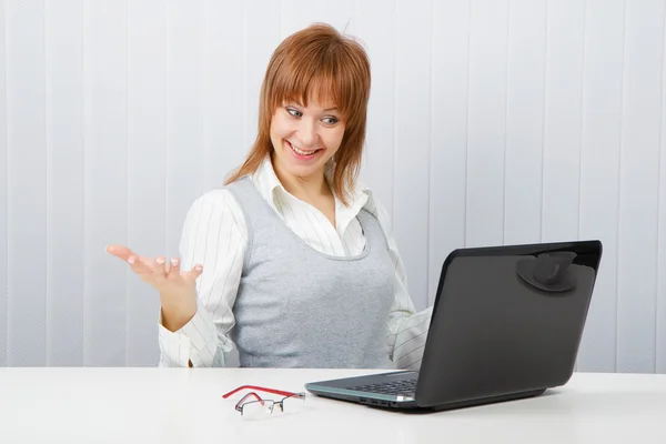 Delighted girl looks at a monitor — Stock Photo, Image