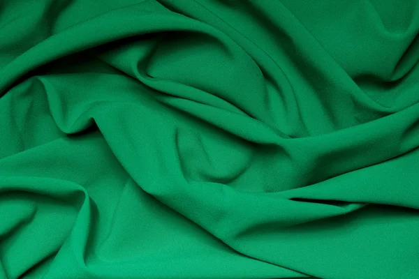 明亮的绿色布料的褶皱。抽象背景 — 图库照片