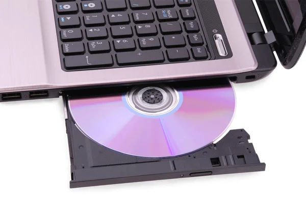 Laptop on white background. DVD disc in the drive — Stock Photo, Image