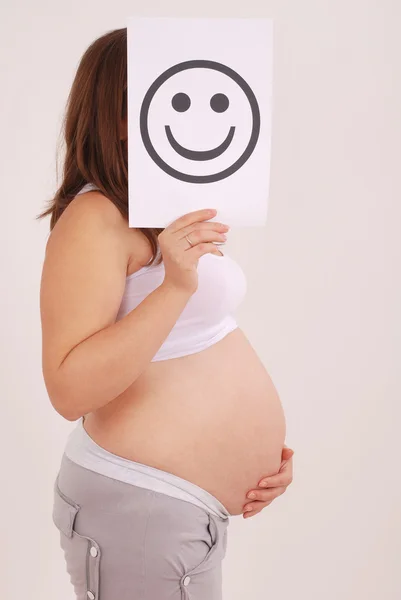 Embarazada hembra con sonriente cara tarjeta . —  Fotos de Stock