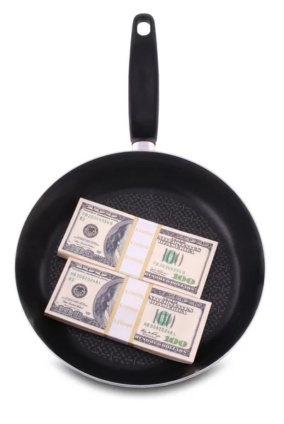 Доллары в сковородке — стоковое фото