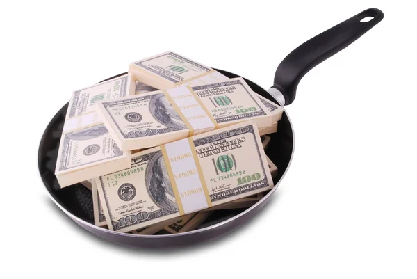 Доллары в сковородке — стоковое фото