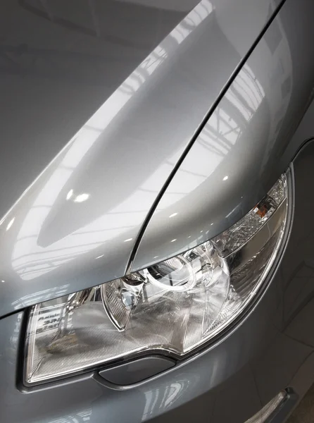 Motor-car headlight and grate of radiator — Stock Photo, Image