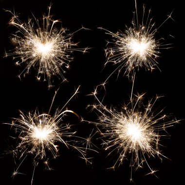 Burning christmas sparkler on black clipart