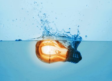 Glowing light bulb in water clipart