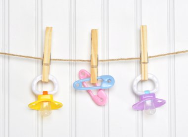 Baby Pacifier Binky Pink on a Clothesline clipart