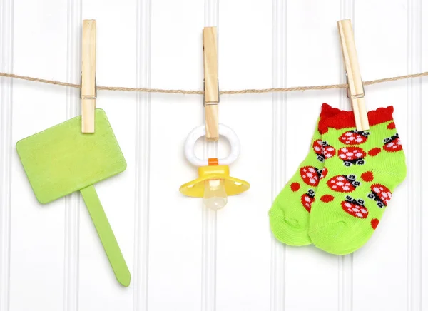 Baby Goods and Blank Sign on a Clothesline — Stock Photo, Image