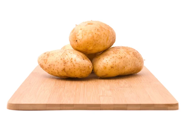 Fresh potatoes with board on a white background — Stock Photo, Image