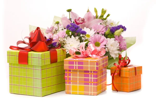 Magnificent bouquet and present boxes on a white — Stock Photo, Image
