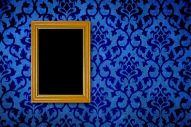 Gold frame on a vintage blue wall background clipart