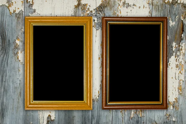 Gold frame on a old wooden wall background. — Stock Photo, Image