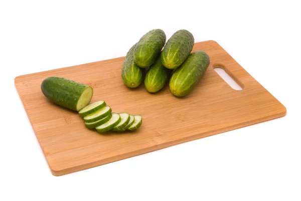 Fresh cucumbers on a chopping board — Stock Photo, Image