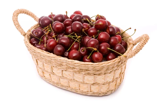Red cherries in wooden basket isolated on white — Stock Photo, Image