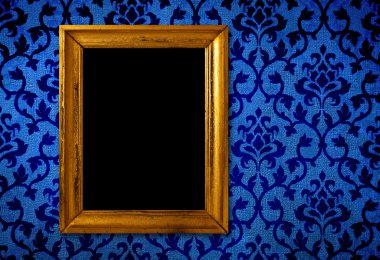 Gold frame on a vintage blue wall background clipart