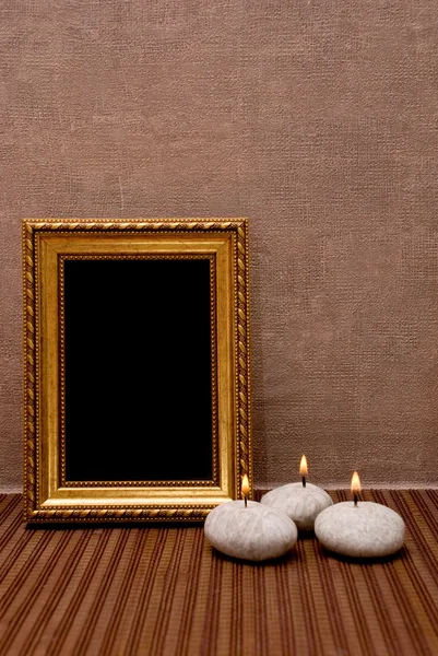 Empty picture frame with candles — Stock Photo, Image