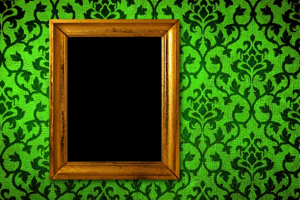 Gold frame on a vintage green wall background — Stock Photo, Image