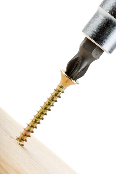 Closeup image of screwdriver and single screw in board on white — Stock Photo, Image