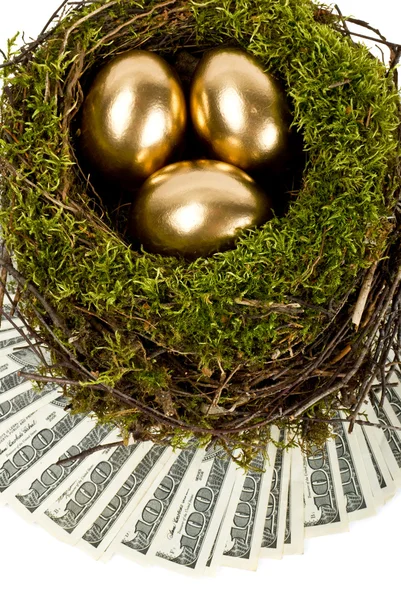 Três ovos dourados no ninho. Um símbolo de ganhar dinheiro e chupar — Fotografia de Stock