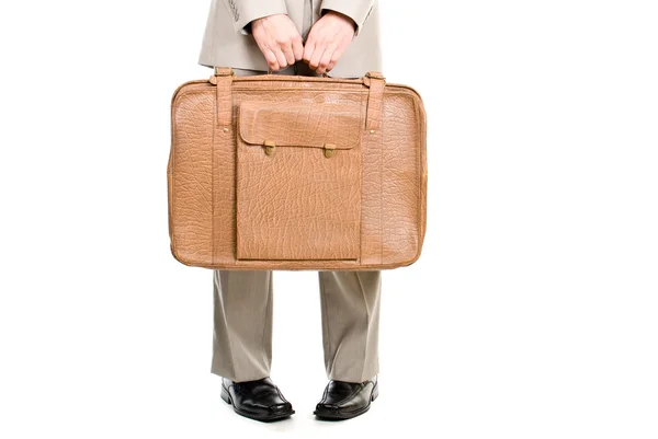 stock image Man holding an old suitcase isolated over white background