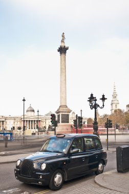 Taxi on Nelsons Column at London, England clipart