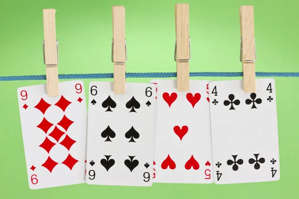 Playing cards hung on clothesline — Stock Photo, Image