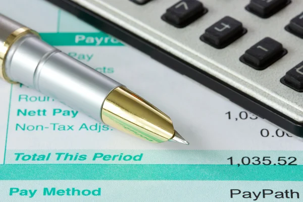 Pen,calculator and payslip — Stock Photo, Image