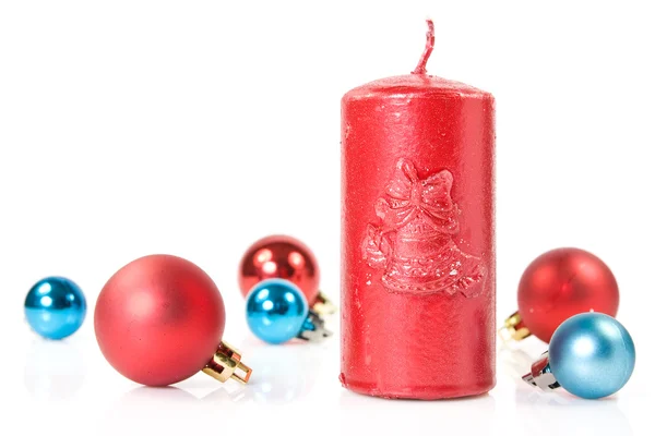 Red candle and christmas baubles — Stock Photo, Image