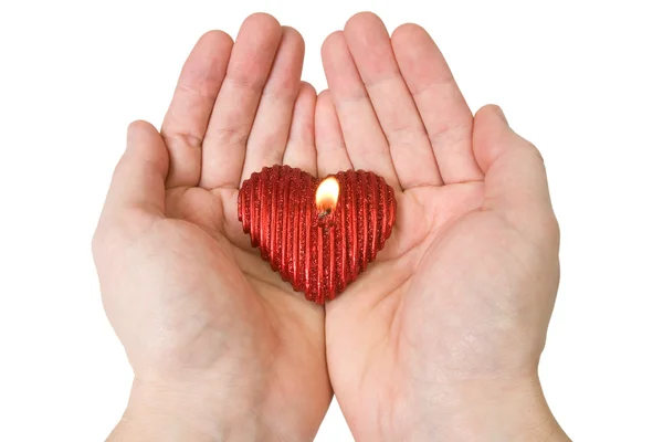 Vela formato de coração nas mãos — Fotografia de Stock