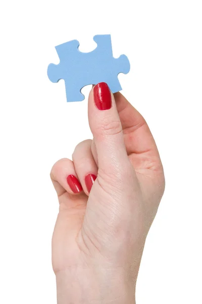 Hand met een stukje van blauwe puzzel — Stockfoto