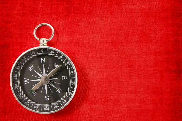 Compass on the vivid red background — Stock Photo, Image