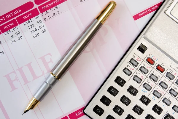 Ink pen,calculator and payslip — Stock Photo, Image