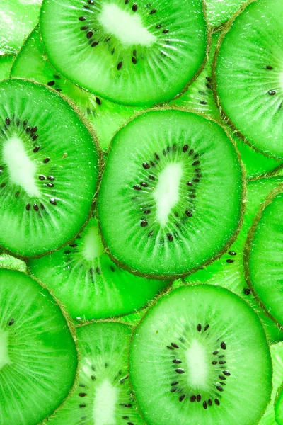 Vivid green background of kiwi slices — Stock Photo, Image