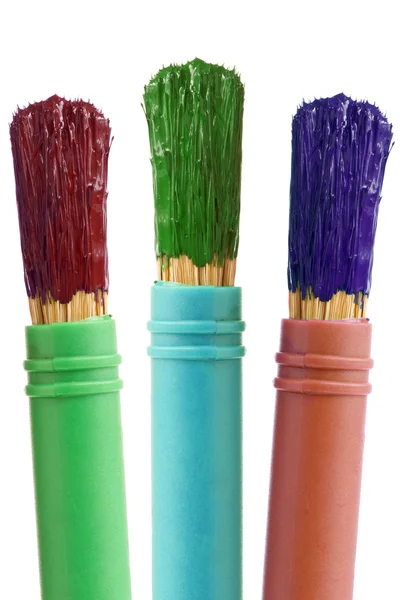 Three paintbrushes with color paint — Zdjęcie stockowe