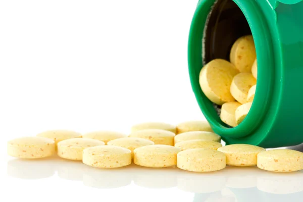Pilulku láhev s žlutým práškům — Stock fotografie